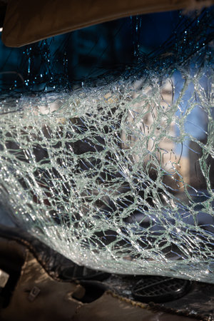 KYIV, UKRAINE - Mar. 20, 2022: War in Ukraine. Car damaged by falling debris after Russian rocket...