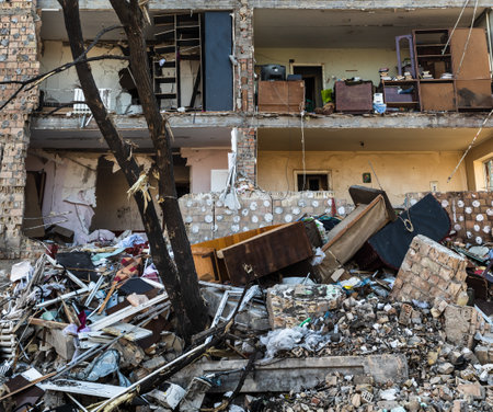 KYIV, UKRAINE - Mar. 21, 2022: War in Ukraine. Residential building damaged by falling debris after...