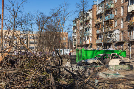 KYIV, UKRAINE - Mar. 21, 2022: War in Ukraine. Residential building and cars damaged by falling...
