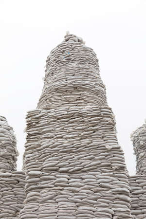 KYIV, UKRAINE - Apr. 01, 2022: Volunteers complete to cover a monument of the Princess Olga, Apostle Andrew, Cyril and Methodius of sand bags to protect it in fear of a possible bombardmentのeditorial素材