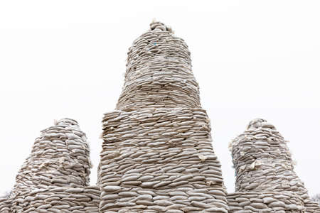 KYIV, UKRAINE - Apr. 01, 2022: Volunteers complete to cover a monument of the Princess Olga, Apostle Andrew, Cyril and Methodius of sand bags to protect it in fear of a possible bombardmentのeditorial素材