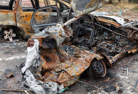 KYIV REG., UKRAINE - Apr. 02, 2022: A destroyed and burnt cars seen on a Kyiv-Zhytomyr highway 20 km...