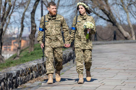 KYIV, UKRAINE - Apr. 07, 2022: War and Love. Members of the Kyiv territorial defense married in Kyiv...