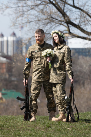 KYIV, UKRAINE - Apr. 07, 2022: War and Love. Members of the Kyiv territorial defense married in Kyiv under the laws of martial law, Kyiv, Ukraineのeditorial素材
