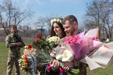 KYIV, UKRAINE - Apr. 07, 2022: War and Love. Members of the Kyiv territorial defense married in Kyiv under the laws of martial law, Kyiv, Ukraineのeditorial素材