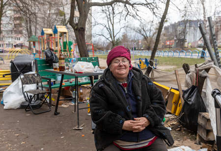 BUCHA, UKRAINE - Apr. 06, 2022: Local residents of Bucha from apartments and houses destroyed by the...
