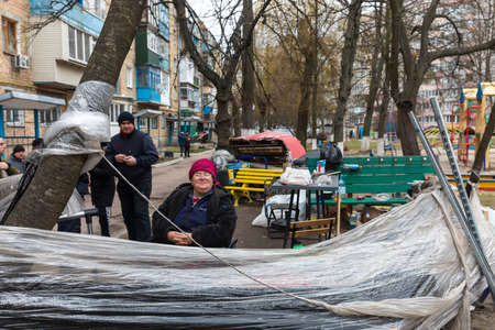 BUCHA, UKRAINE - Apr. 06, 2022: Local residents of Bucha from apartments and houses destroyed by the Russian military are forced to live on the streetのeditorial素材