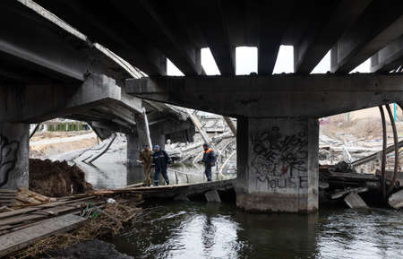 IRPIN, UKRAINE - Apr. 10, 2022: Destroyed bridge over the Irpin River at the entrance to the city of Irpin as a result of the attack of Russian troopsのeditorial素材