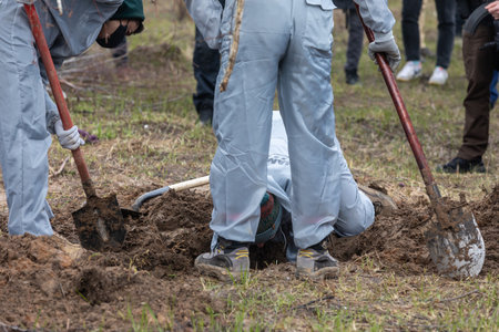 BUCHA, UKRAINE - Apr. 12, 2022: Genocide in Bucha. Forensic police officers exhume bodies in Bucha, outskirts of Kyiv, Ukraine.のeditorial素材