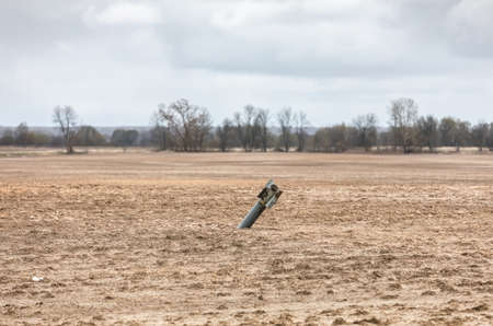 CHERNIHIV REG., UKRAINE - Apr. 18, 2022: An unexploded rocket projectile in the middle of a field near Chernihiv.のeditorial素材