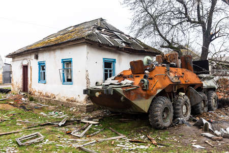 Chernihiv reg., Ukraine - Apr 20, 2022: Burnt cars and destroyed military equipment on the streets of the village as a result of an attack by Russian invadersのeditorial素材