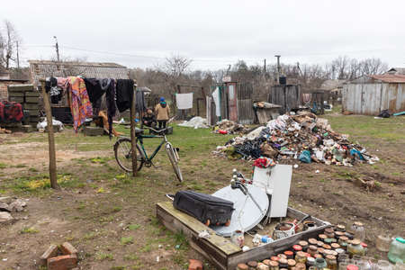 Chernihiv reg., Ukraine - Apr 20, 2022: Disorder and garbage after the Russian occupation in the courtyards of the houses of local residents. People are trying to put things in order near their homesのeditorial素材
