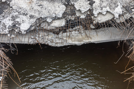 MAKARIV, KYIV REG., UKRAINE - Apr. 23, 2022: War of Russia against Ukraine. Damaged bridge in the village of Makariv as a result of the invasion of Russian invadersのeditorial素材