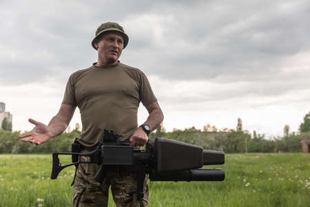 KYIV, UKRAINE - May 14, 2022: A serviceman holds an anti-drone rifle purchased with funds raised...
