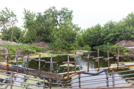 IRPIN, UKRAINE - Jun. 17, 2022: War of Russia against Ukraine. Crosses are attached to the destroyed Irpin bridge, Irpin town, Ukraineのeditorial素材