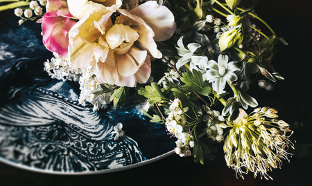 Romantic bouquets of flowers. Home decor and flowers arranging. In composition used tulip, allium, tarantula and hawthorn flowersの写真素材