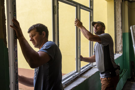 CHERNIHIV, UKRAINE - Jul. 27, 2022: War in Ukraine. Preparation for the new academic year and repair work in the Chernihiv school. New windows installing in School 35 in Chernihiv, Ukraineのeditorial素材