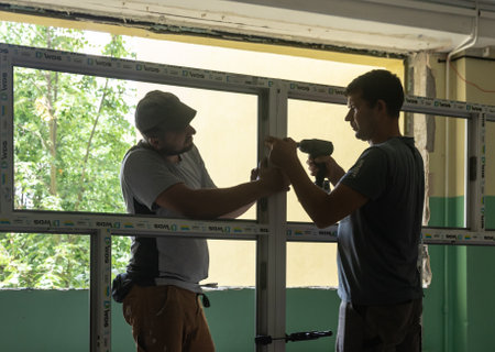 CHERNIHIV, UKRAINE - Jul. 27, 2022: War in Ukraine. Preparation for the new academic year and repair work in the Chernihiv school. New windows installing in School 35 in Chernihiv, Ukraineのeditorial素材