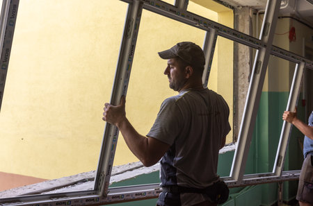 CHERNIHIV, UKRAINE - Jul. 27, 2022: War in Ukraine. Preparation for the new academic year and repair work in the Chernihiv school. New windows installing in School 35 in Chernihiv, Ukraineのeditorial素材