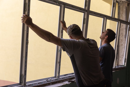 CHERNIHIV, UKRAINE - Jul. 27, 2022: War in Ukraine. Preparation for the new academic year and repair work in the Chernihiv school. New windows installing in School 35 in Chernihiv, Ukraineのeditorial素材