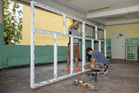 CHERNIHIV, UKRAINE - Jul. 27, 2022: War in Ukraine. Preparation for the new academic year and repair work in the Chernihiv school. New windows installing in School 35 in Chernihiv, Ukraineのeditorial素材
