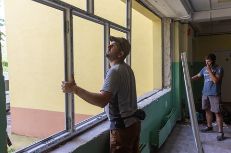 CHERNIHIV, UKRAINE - Jul. 27, 2022: War in Ukraine. Preparation for the new academic year and repair work in the Chernihiv school. New windows installing in School 35 in Chernihiv, Ukraineのeditorial素材