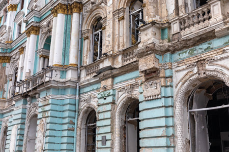 KHARKIV, UKRAINE - Aug. 01, 2022: Damaged architectural monument of the city of Kharkiv. Destroyed building in historical downtown as a consequence of Russian shelling in Kharkiv.のeditorial素材