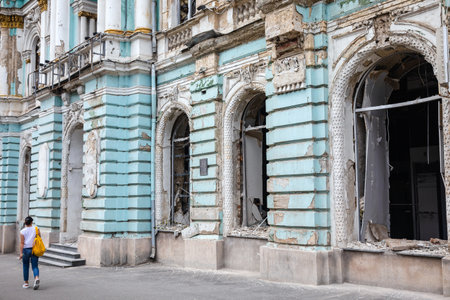 KHARKIV, UKRAINE - Aug. 01, 2022: Damaged architectural monument of the city of Kharkiv. Destroyed building in historical downtown as a consequence of Russian shelling in Kharkiv.のeditorial素材