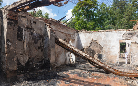 KHARKIV REG, UKRAINE - Jul. 30, 2022: An employee of Skovoroda Museum tells how the house of the Ukrainian philosopher Hryhoriy Skovoroda Museum was destroyed by missile strike in Kharkiv regionのeditorial素材
