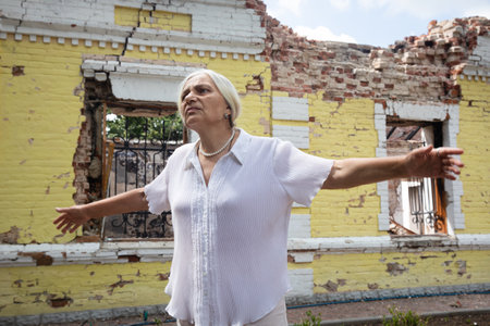 KHARKIV REG, UKRAINE - Jul. 30, 2022: An employee of Skovoroda Museum tells how the house of the Ukrainian philosopher Hryhoriy Skovoroda Museum was destroyed by missile strike in Kharkiv regionのeditorial素材