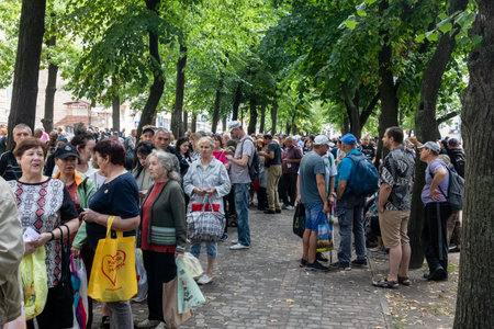 KHARKIV, UKRAINE - Aug. 02, 2022: A queue of people in need of humanitarian assistance. Volunteer...
