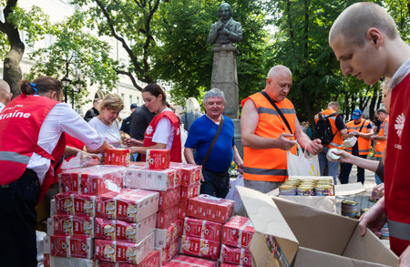 KHARKIV, UKRAINE - Aug. 02, 2022: Volunteers distribute boxes of cereal to those in need.Volunteer...
