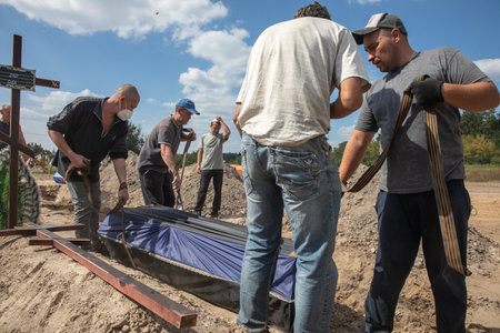 BUCHA, UKRAINE - Sep. 02, 2022: Burial of the remains of 13 unidentified and two identified people who were killed in the Bucha district during the Russian occupationのeditorial素材