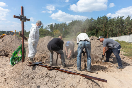 BUCHA, UKRAINE - Sep. 02, 2022: Burial of the remains of 13 unidentified and two identified people who were killed in the Bucha district during the Russian occupationのeditorial素材