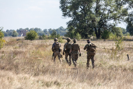 KYIV REG., UKRAINE - Sep. 08, 2022: A group of military men is seen in the field during a test of an evacuation robot which will be used for evacuation purpose on the frontlineのeditorial素材