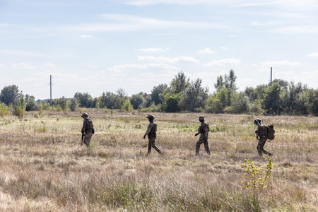 KYIV REG., UKRAINE - Sep. 08, 2022: A group of military men is seen in the field during a test of an evacuation robot which will be used for evacuation purpose on the frontlineのeditorial素材