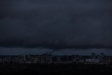 View of Kyiv from the observation deck in the evening during a blackout. Dark houses and unlit streets are visible.のeditorial素材