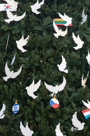KYIV, UKRAINE - Dec. 22, 2022: Christmas tree on Sofiyivska Square in Kyiv isdecorated with white pigeons and flags of countries that help Kyiv to cope with the war-related challenges and consequencesのeditorial素材