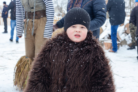 Krasnoilsk, Ukraine - January 14, 2018: Malanka or Generous Evening is a Ukrainian national and church holiday. Ancient pagan ritual of Malanka. People in festive carnival and national costumes.のeditorial素材