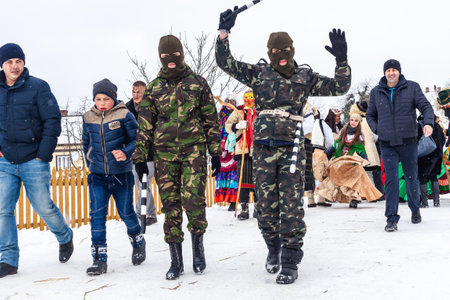 Krasnoilsk, Ukraine - January 14, 2018: Malanka or Generous Evening is a Ukrainian national and church holiday. Ancient pagan ritual of Malanka. People in festive carnival and national costumes.のeditorial素材