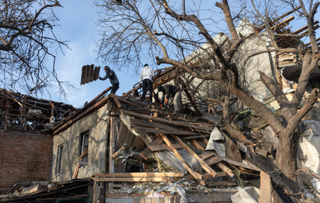 KYIV, UKRAINE - Jan. 03, 2023: War in Ukraine. Volunteers clear and dismantle debris at the site of a Russian missile attack on December 31のeditorial素材