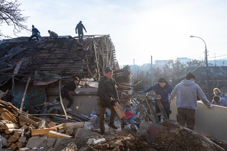 KYIV, UKRAINE - Jan. 03, 2023: War in Ukraine. Volunteers clear and dismantle debris at the site of...
