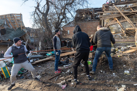 KYIV, UKRAINE - Jan. 03, 2023: War in Ukraine. Volunteers clear and dismantle debris at the site of...