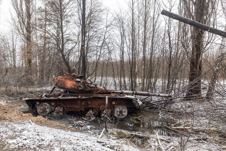 A tank of Russian invaders destroyed as a result of fierce and heavy fighting near a village Kuhari in the Kyiv regionの写真素材
