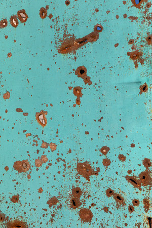 The surface of the metal gates is covered with splinter marks from exploding shells in the village of Bogorodichne, Donetsk region, Ukraineのeditorial素材