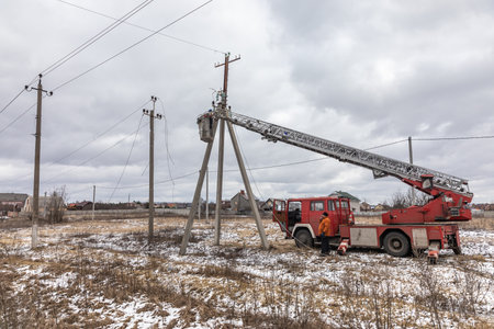 KHARKIV REG., UKRAINE - Mar. 02, 2023: A team of electricians is seen working to restore a power line in Kharkiv regionのeditorial素材