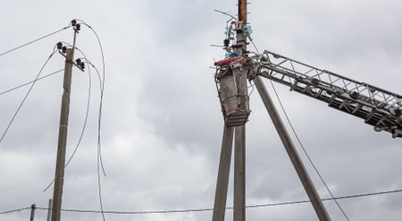 KHARKIV REG., UKRAINE - Mar. 02, 2023: A team of electricians is seen working to restore a power line in Kharkiv regionのeditorial素材