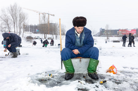 KYIV, UKRAINE - Jan. 14, 2024: Ice fishing on the Dnieper River in Kyiv. Despite the Russian Federations ongoing war against Ukraine, Kyiv, the capital of Ukraine, continues to live a peaceful life.のeditorial素材
