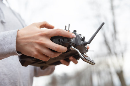 LVIV, UKRAINE - Feb. 11, 2024: A young woman is seen studying to operate an FPV drone flight using a...