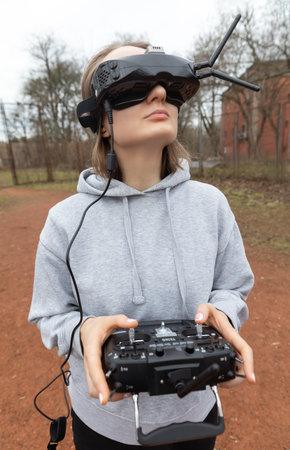 LVIV, UKRAINE - Feb. 11, 2024: A young woman is seen wearing virtual reality goggles and a remote...